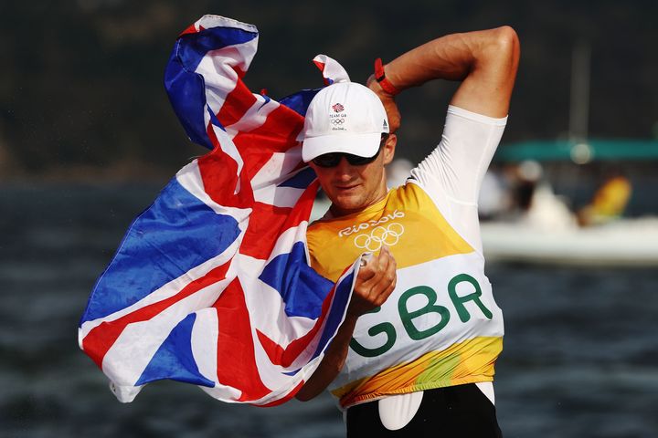 Giles Scott of Great Britain celebrates winning gold in the Finn class