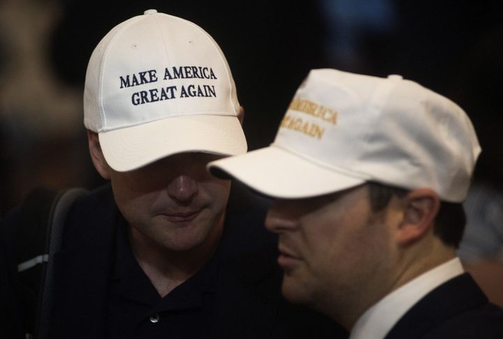 Attendees wear hats reading 'Make America Great Again' during a goodbye reception with Donald Trump, 2016 Republican presidential nominee, not pictured at the Westin Hotel in Cleveland, Ohio, U.S., on Friday, July 22, 2016.