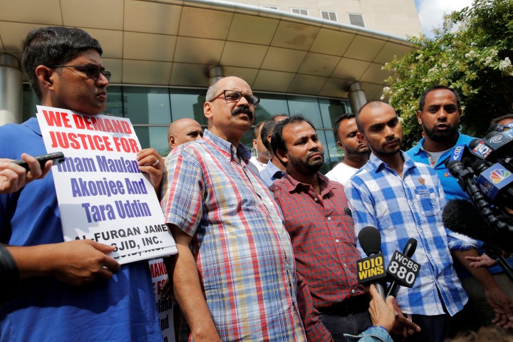 Imam Maulama Akonjee's son Saif Akonjee (2nd R) speaks to media at the Queens Criminal Court following the arraignment of alleged murderer Oscar Morel in Queens, New York, U.S., August 16, 2016.