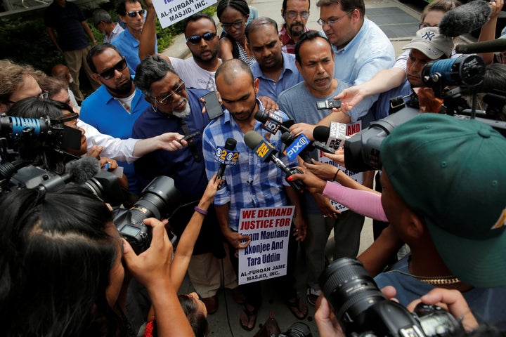 Imam Maulama Akonjee's son Saif Akonjee (C) and Mashuk Uddin, brother of Thara Uddin (R) speak to media at the Queens Crimina