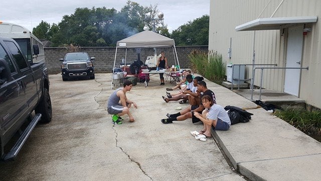 Folks waiting in line for food. 