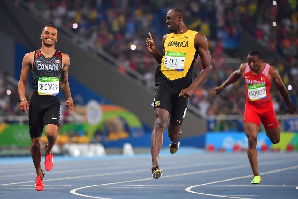 Jamaica's Usain Bolt jokes with Canada's Andre De Grasse after they crossed the finish line in the Men's 200m Semifinal in Ri
