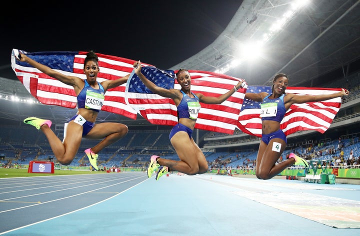 Bronze medalist Kristi Castlin, gold medalist Brianna Rollins and silver medalist Nia Ali of the United States celebrate with American flags.