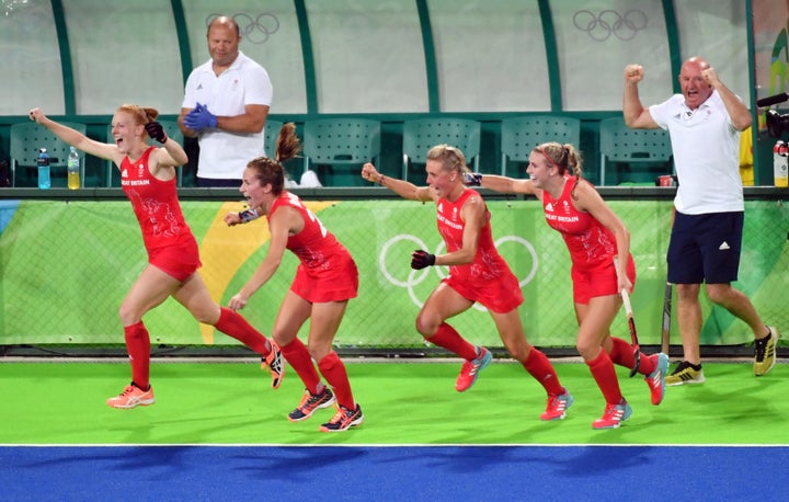 Britain's players celebrate after winning the women's semifinal field hockey.