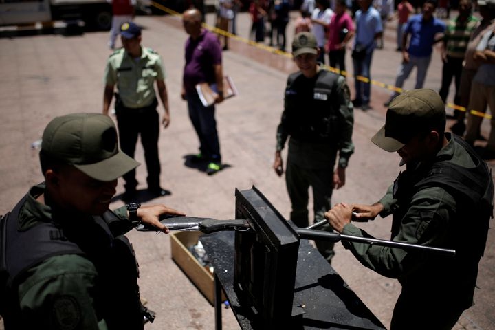 Venezuelan National Guard destroy a weapon during an exercise to disable seized weapons in Caracas.