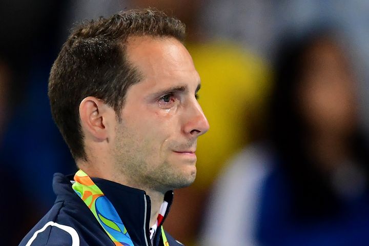 Renaud Lavillenie cries on the podium as the crowd boos him for the second straight night.