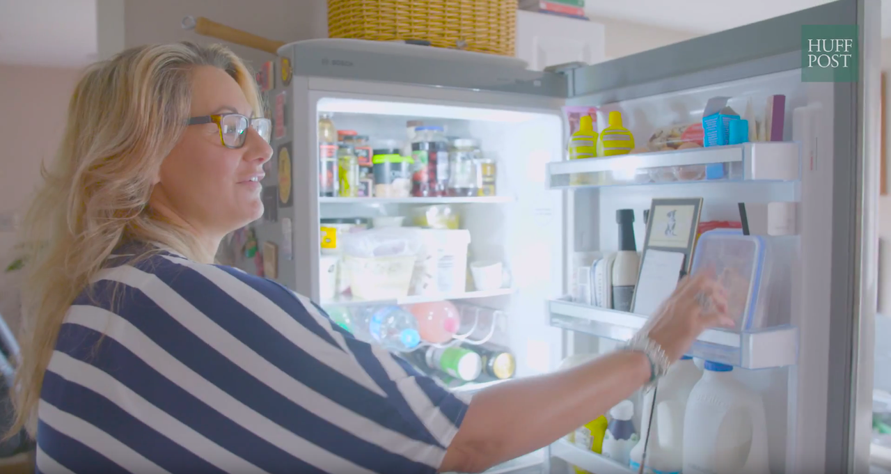 Yates demonstrating the 'smart fridge' with cameras inside.