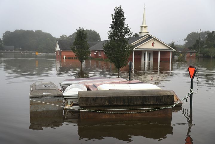 Caskets are seen floating in flood waters near a cemetery on Aug. 17 in Gonzales, Louisiana.