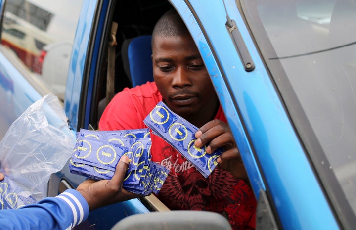 A taxi driver is given condoms by a member of the Treatment Action Campaign (TAC) as they campaign for safe sex in Daveyton, outside Johannesburg November 27, 2014. The activists want to educate people about how HIV is spread and most importantly, how it can be prevented.