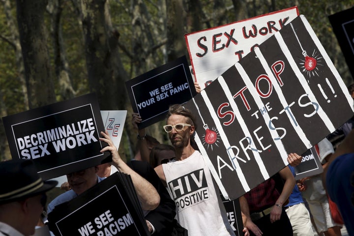 Demonstrators hold signs as they protest the arrests of male escort service Rentboy.com staffers in 2015. 