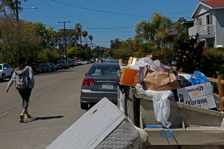 Trash from weekend partying sits in a dumpster on Sabado Tarde in the aftermath of the riot that broke out last Saturday nigh