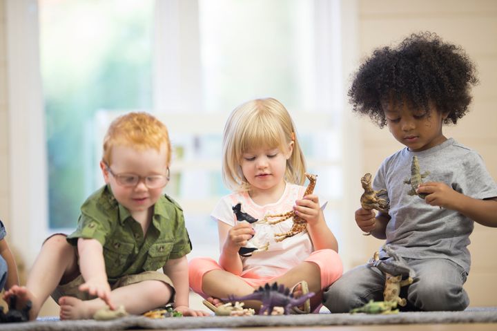 A multi-ethnic group of toddlers are playing with toy animals together in preschool. Christopher Futcher via Getty Images