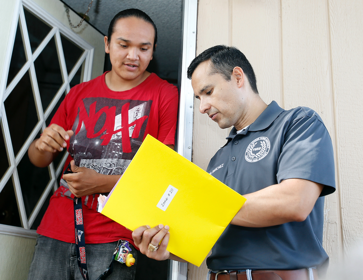 Tucson Unified School District Superintendent Dr. H.T. Sánchez, right, talks to a teen about why he should re-enroll in school.