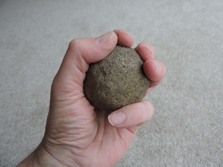 One of 55 round stone artifacts the scientists analyzed to determine their use as throwing weapons.