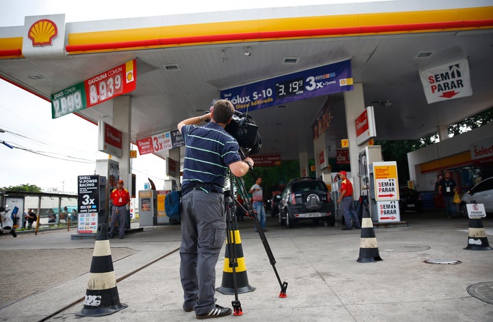 A television cameraman films at the gasoline station where U.S. swimmers Ryan Lochte, Jimmy Feigen, Jack Conger and Gunnar Bentz were accused by staff of having caused damage, in Rio de Janeiro,