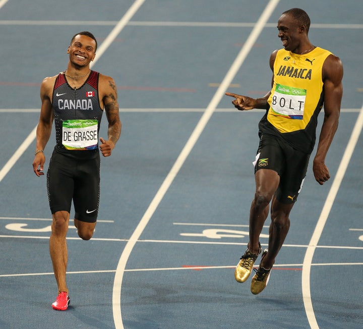 Bolt and De Grasse laugh following a semi-final of the men's 200-meter dash.