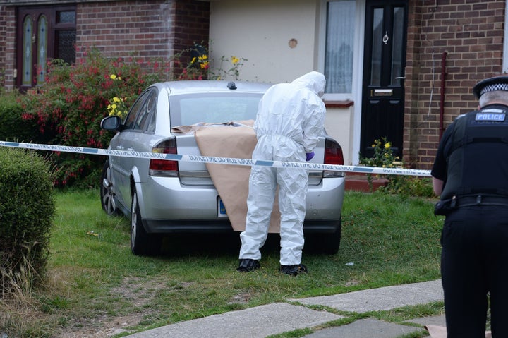 A forensics officer examines evidence at the scene of the attack 