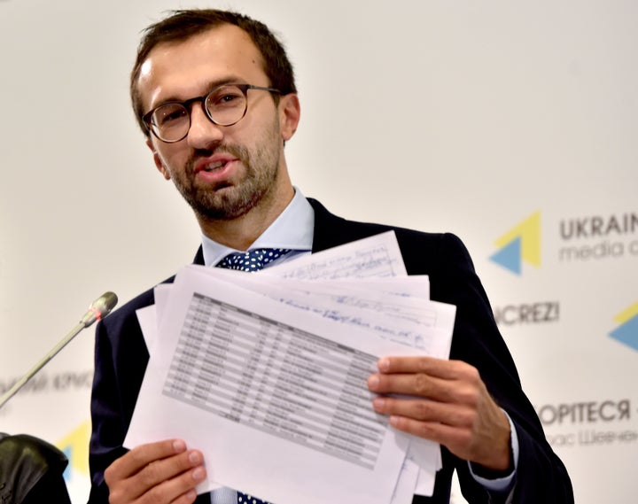 Ukrainian lawmaker Serhiy Leshchenko holds pages he alleges show signed payments from the party of Ukraine's former president Viktor Yanukovych to Donald Trump's presidential campaign.