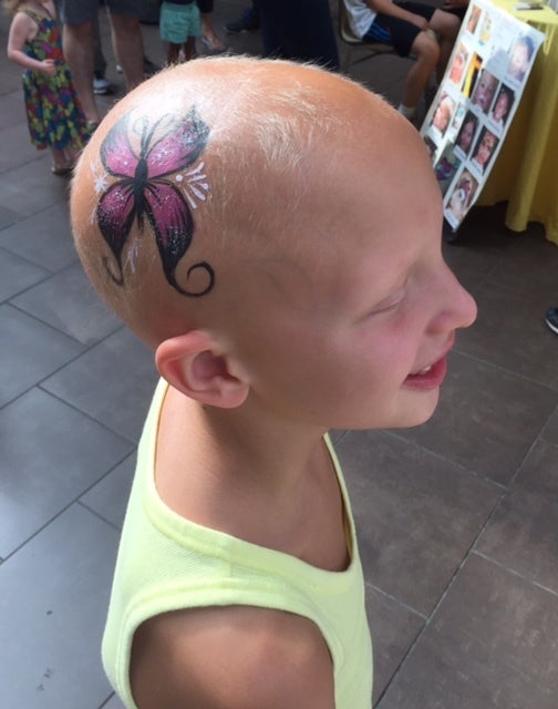 Amelia with her head painted this summer.