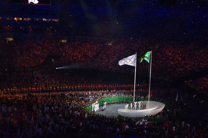 The Brazilian and Olympic flag fly over the opening ceremony