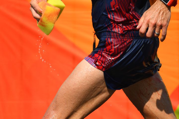 <strong>Diniz sponges away blood as he competes in the Men's 50km Race Walk.</strong>