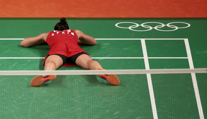 Spain's Carolina Marin celebrates her gold-medal badminton win Friday. Also how we all feel the morning after watching one too many Usain Bolt triple-triples...