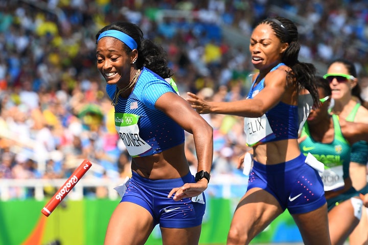 USA's Allyson Felix attempts to hand the baton to USA's English Gardner in the Women's 4 x 100m Relay Round 1 during the athletics event at the Rio 2016 Olympic Games at the Olympic Stadium in Rio de Janeiro on August 18, 2016.