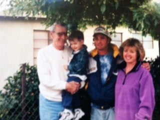 Michael Paul stands under a tree for a photo with his son, Daniel, his mother, Joan Davis, and his grandfather, Ed Malay. Daniel is now 21 years old.