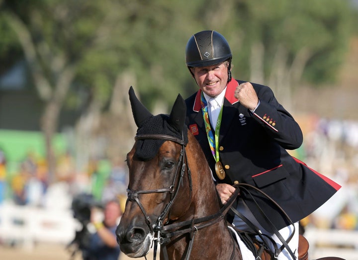 Nick Skelton, 58, celebrates his gold medal.