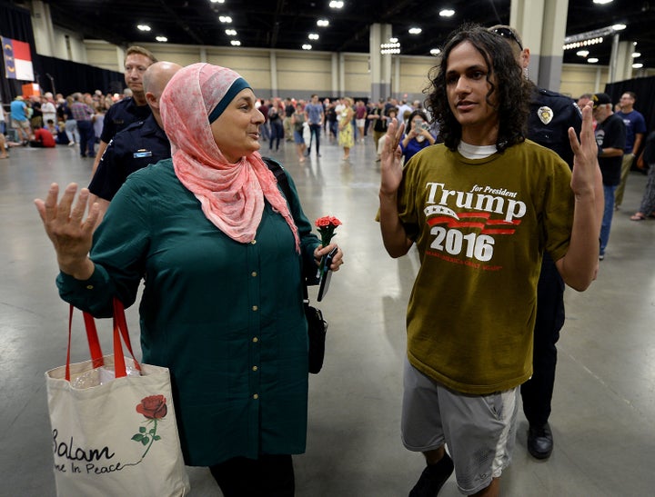 Rose Hamid, left, and Jake Anantha, right, are escorted from the Charlotte Convention Center in Charlotte, N.C., prior to a rally for Donald Trump on Thursday, Aug. 18, 2016.