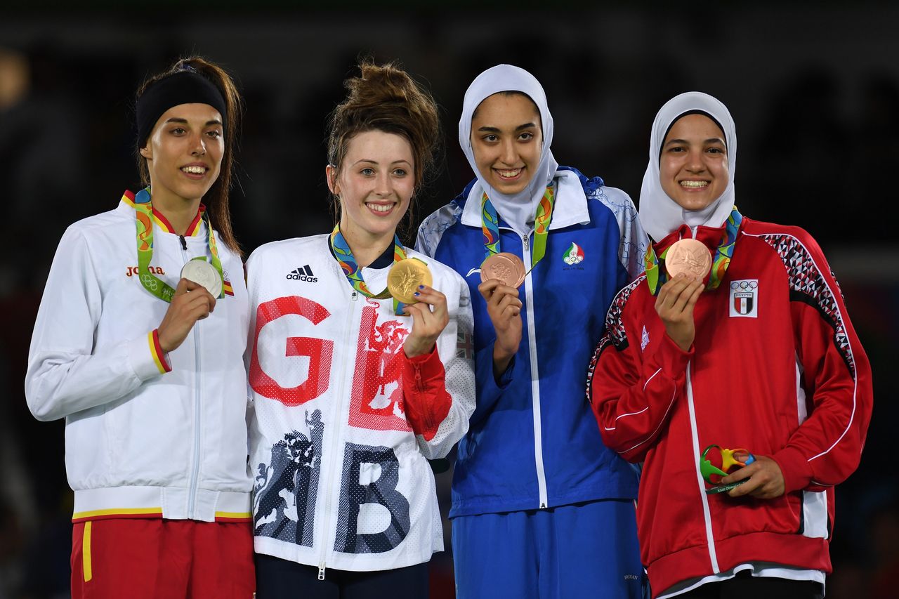 Eva Calvo Gomez of Spain, gold medalist, Jade Jones of Great Britain and bronze medalists Kimia Alizadeh Zenoorin and Hedaya Wahba of Egypt celebrate on the podium