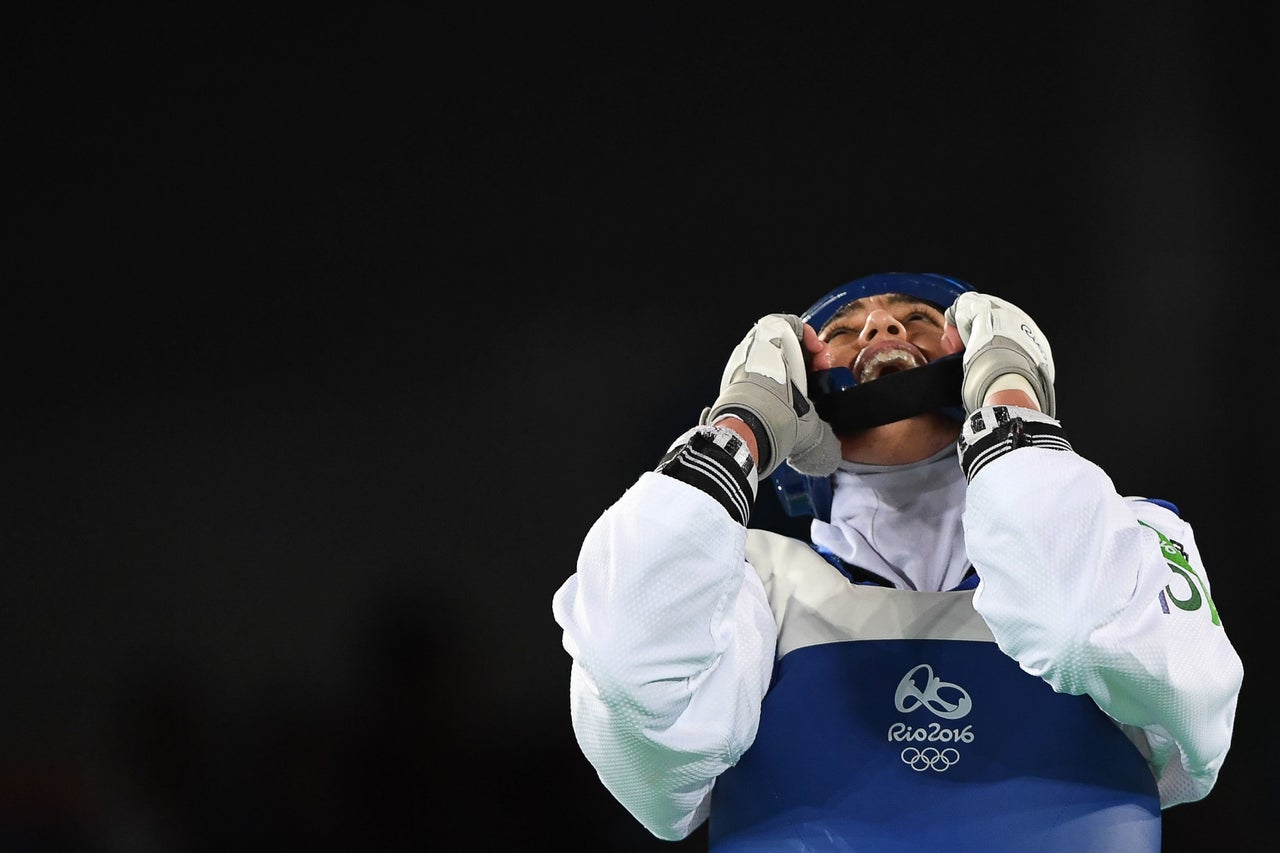 Kimia Alizadeh Zenoorin celebrates after winning against Sweden's Nikita Glasnovic in their womens taekwondo bronze medal bout