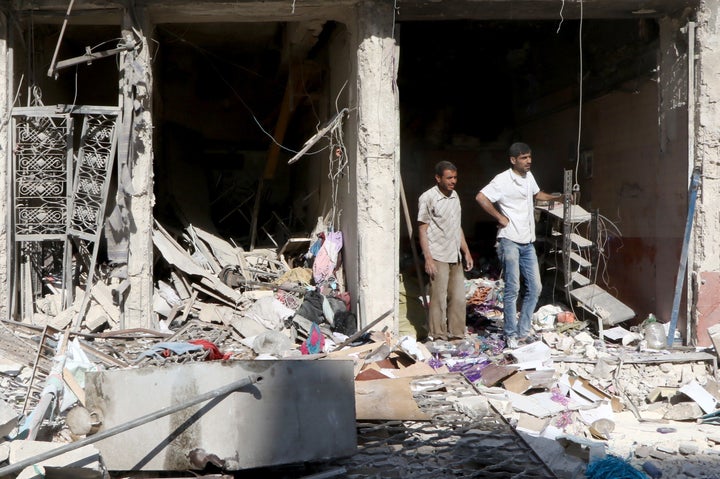 Debris of the buildings are seen after a helicopter belonging to Syrian army hit the residential area with barrel bombs, over opposition controlled Salihin neighborhood of Aleppo, Syria on August 18, 2016.
