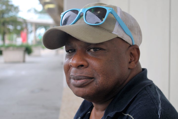 Floyd Norman sits outside the Baton Rouge River Center Arena, which has been turned into a temporary shelter.