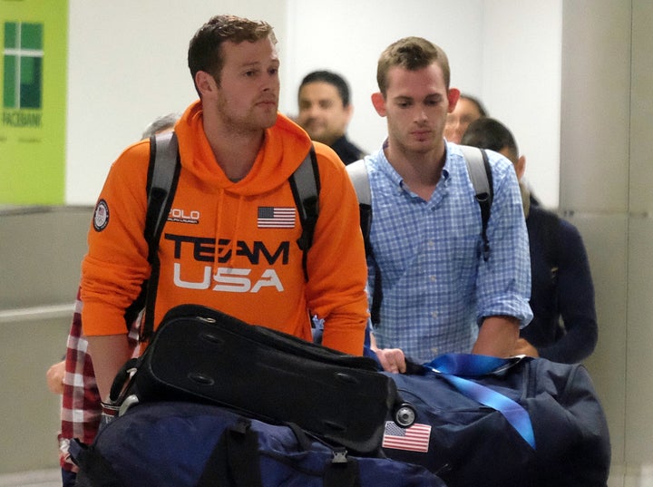 U.S. Swimmers Jack Conger and Gunnar Bentz arrive on an overnight flight from Brazil to Miami.