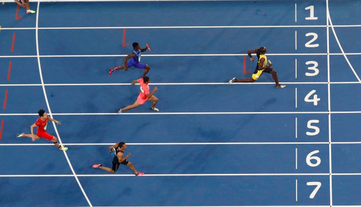 Usain Bolt races toward the finish line to win the gold.