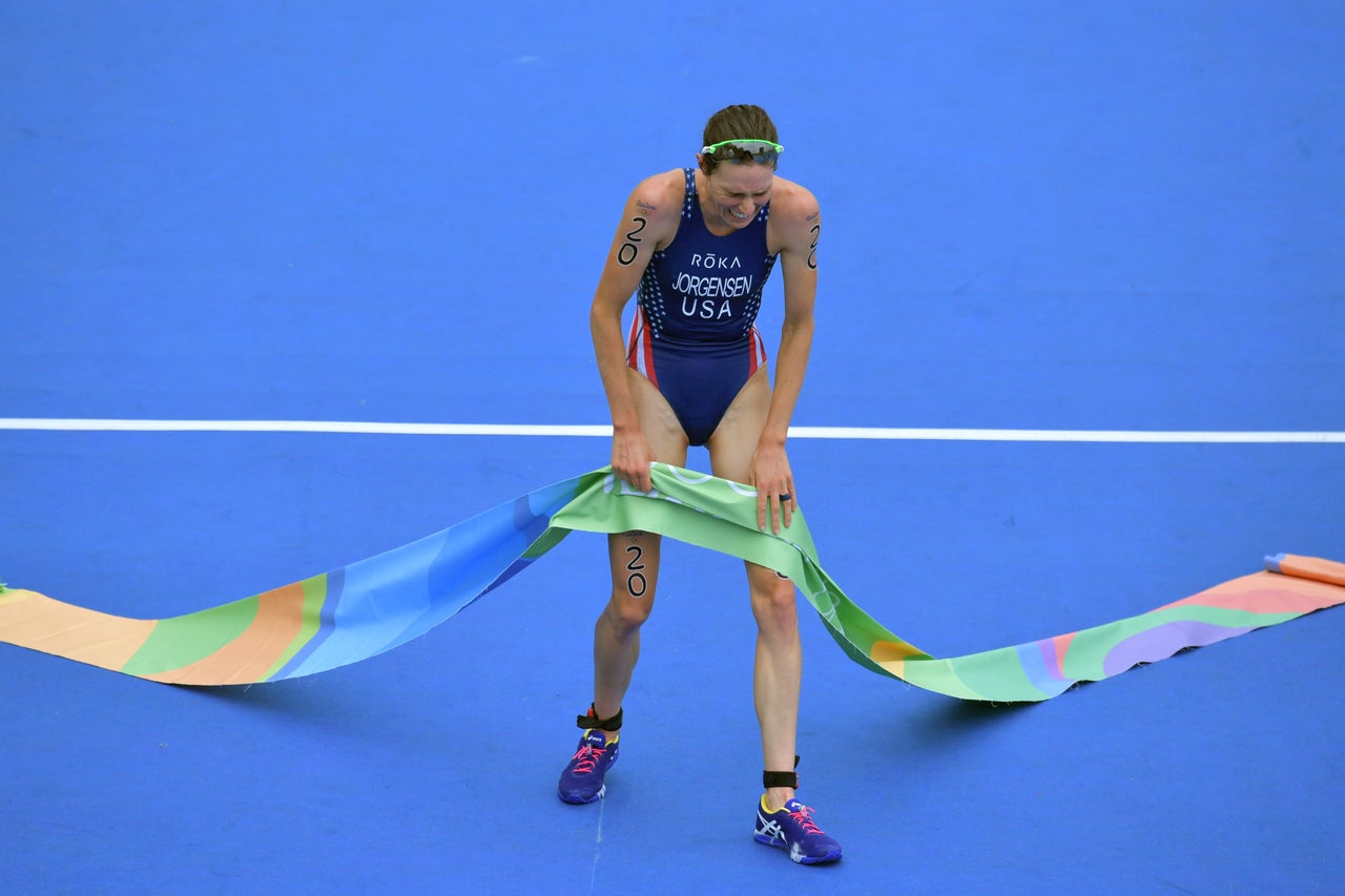 USA's Gwen Jorgensen reacts as she crosses the finish line to win the gold medal in the women's triathlon on August 20, 2016.