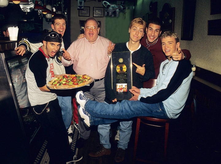 Lou Pearlman poses with *NSYNC: Chris Kirkpatrick, JC Chasez, Lance Bass, Joey Fatone and Justin Timberlake at N.Y.P.D. pizza in Miami, circa 1996.