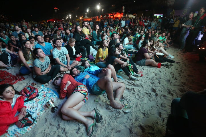 Brazilians watch a live broadcast of the Olympic men's soccer final on Leblon beach in Rio de Janeiro, Aug. 20, 2016.