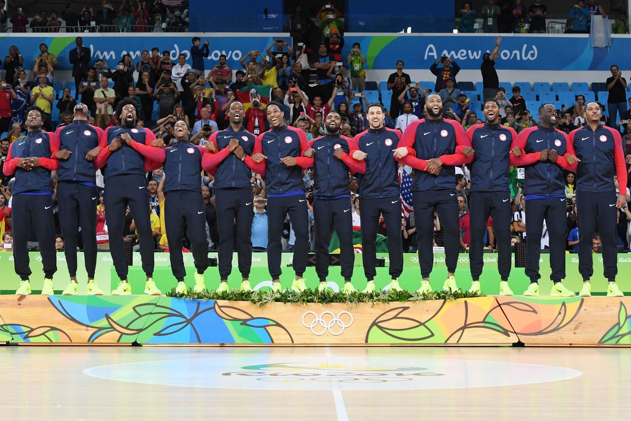 The U.S. men's basketball team locks arms after winning the gold medal.