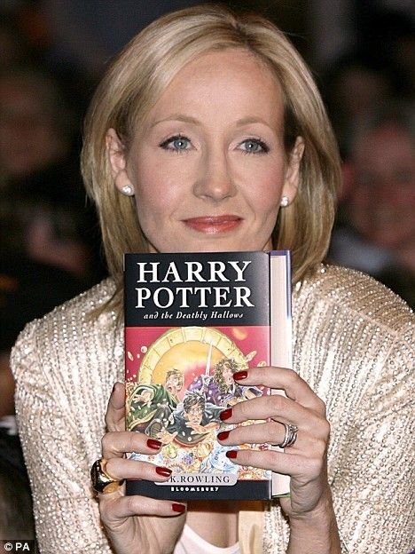 JK Rowling with a copy of her Harry Potter Series