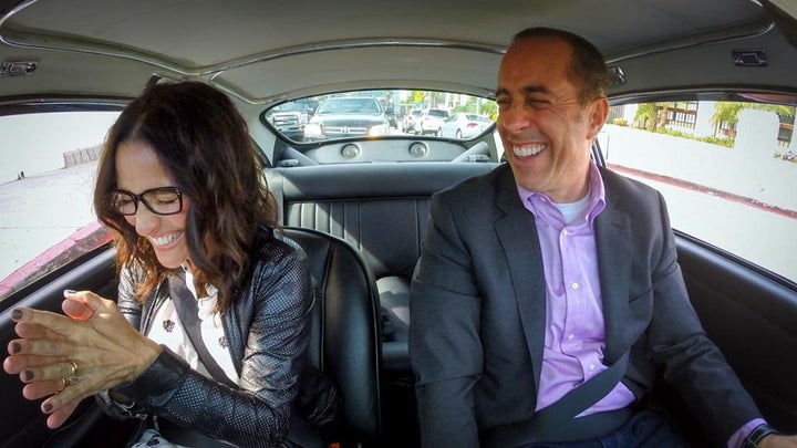 This is Julia Louis-Dreyfus and Jerry Seinfeld in a car getting coffee, not us.