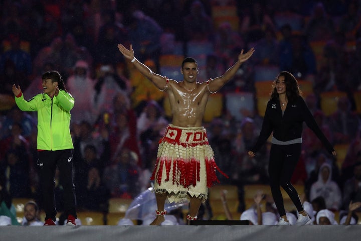 Pita Taufatofua of Tonga jumps on stage during the Closing Ceremony on Day 16 of the Rio 2016 Olympic Games.