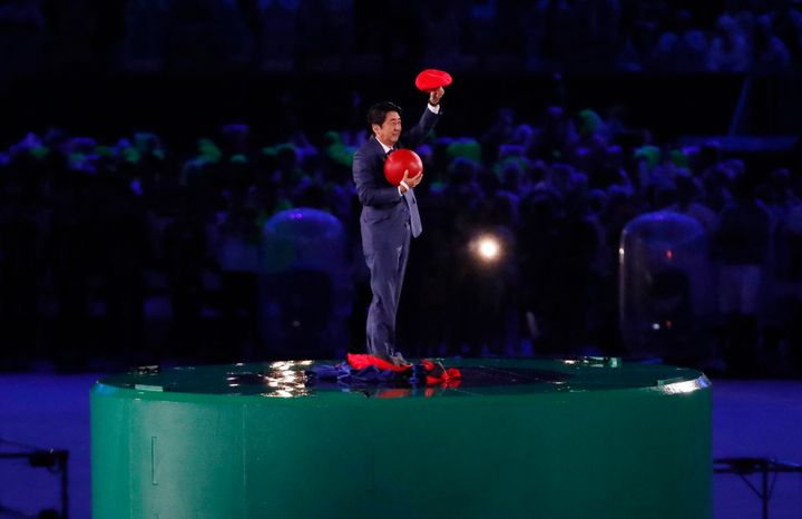 <strong>Japan's Prime Minister Shinzo Abe waves during the closing ceremony</strong>