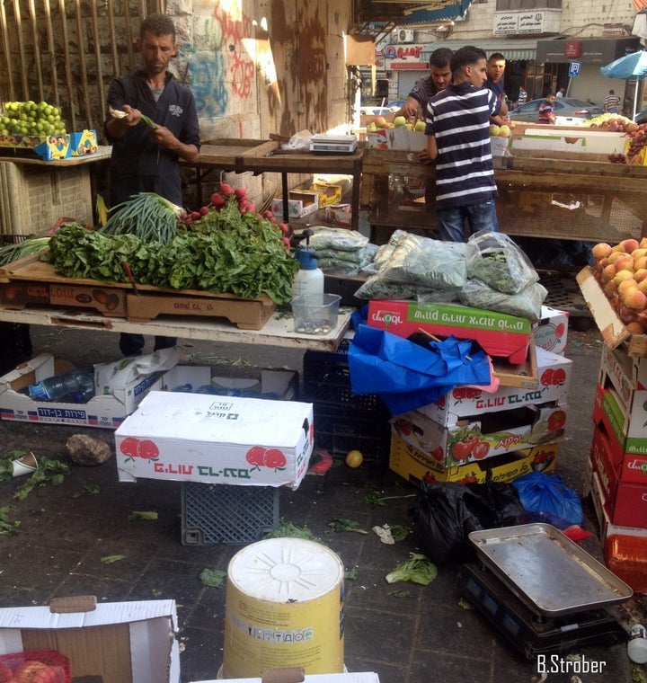 In the market in Ramallah, filled with fruit boxes from Israel.