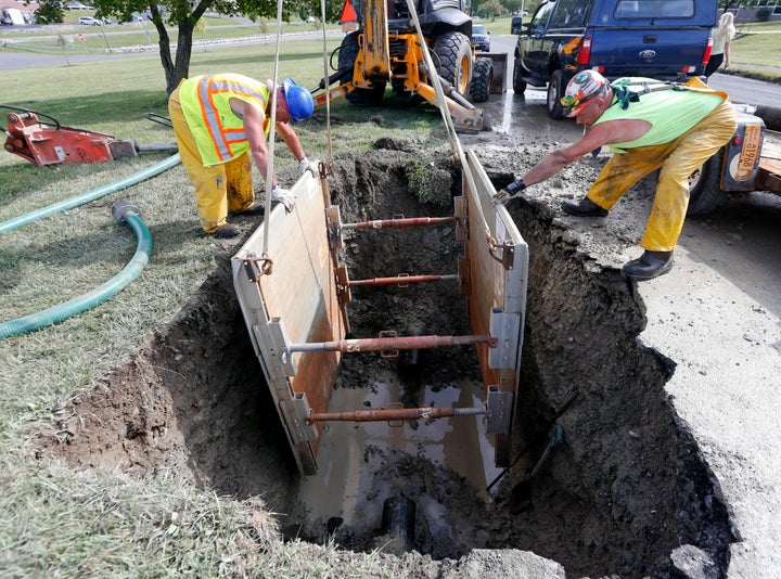 In this Sept. 21, 2015, photo, workers repair a water main break in Syracuse, New York. The U.S. has a large -- and growing -- list of water infrastructure needs and no clear plan to fund them.