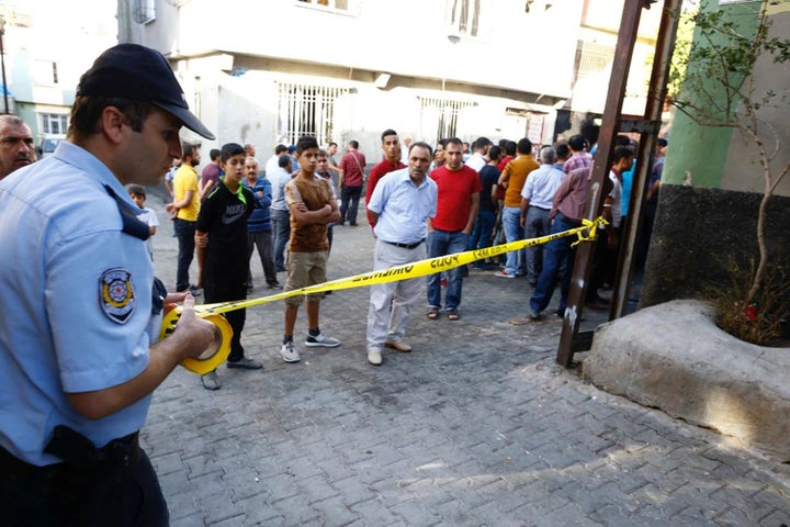 A police officer secures the scene of an explosion where a suspected suicide bomber targeted a wedding celebration in the Turkish city of Gaziantep, Turkey, August 21, 2016.