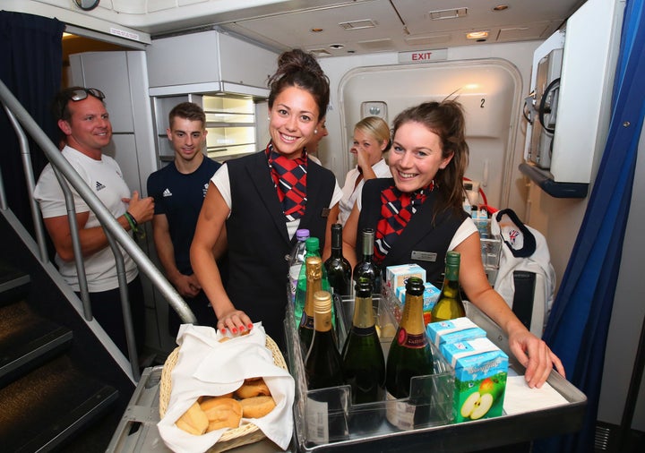 <strong>Sam Quek and Laura Unsworth of Great Britain dress up as cabin crew during the Team GB flight back from Rio.</strong>