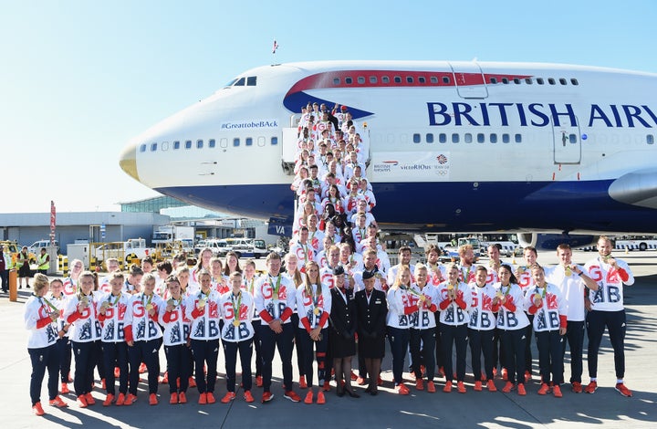 Team GB athletes pose for photos after landing at Heathrow Airport.