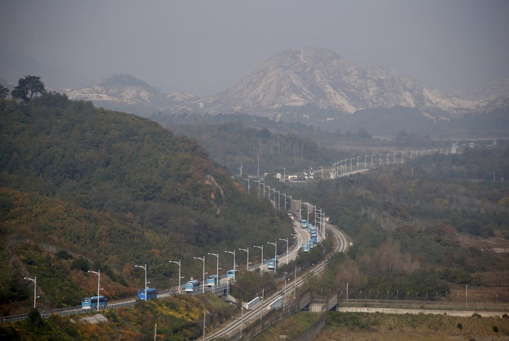 Buses transporting South Korean participants for a reunion travel on the road leading to North Korea's Mount Kumgang resort,